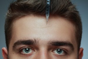 Dysport being injected to remove forehead frown lines.